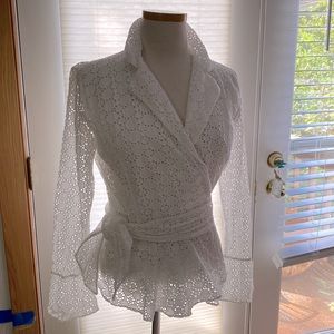 Designer white wrap around 100% cotton eye-lit lace like women’s shirt.